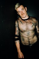 Christopher Bryant dressed in a black see-through shirt