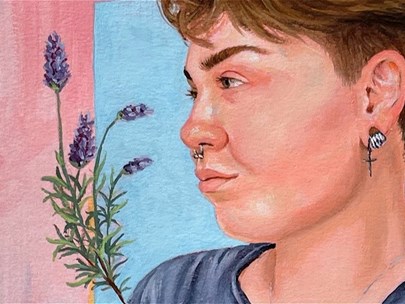 A person with short brown hair and a nose piercing, looking to the left at a sprig of lavender. There is an iced latte to their right, as well as text