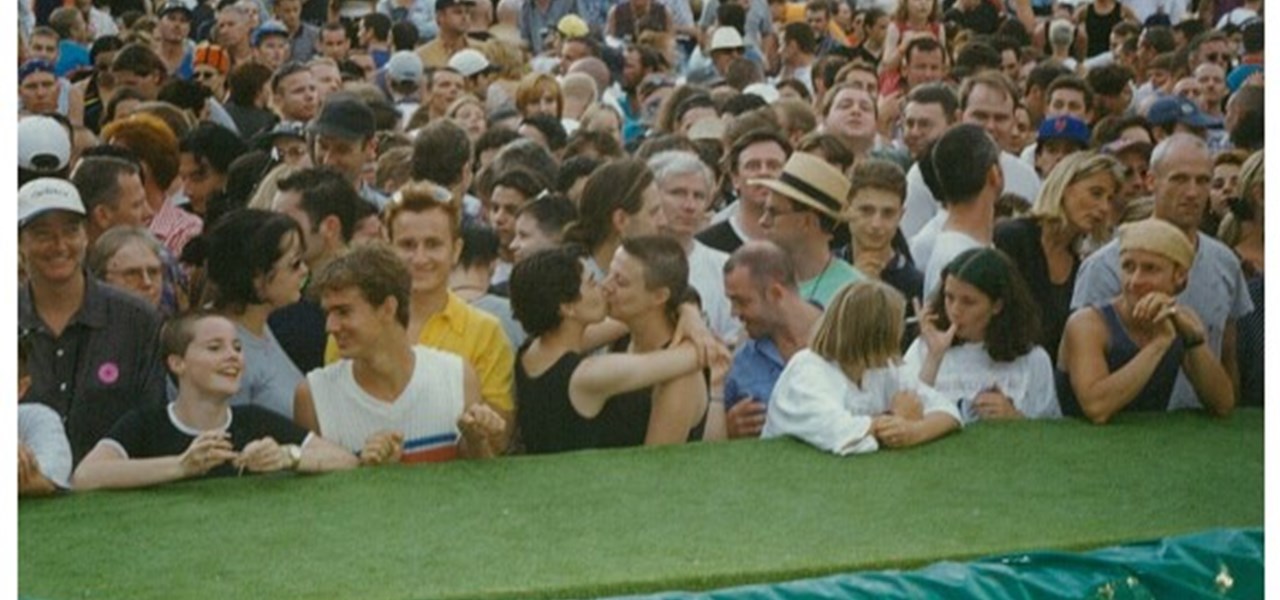 Midsumma Carnival 1996 by Richard Israel and 1997 by Virginia Selleck: the audience with those at the front leaning on the fake lawn covered catwalk