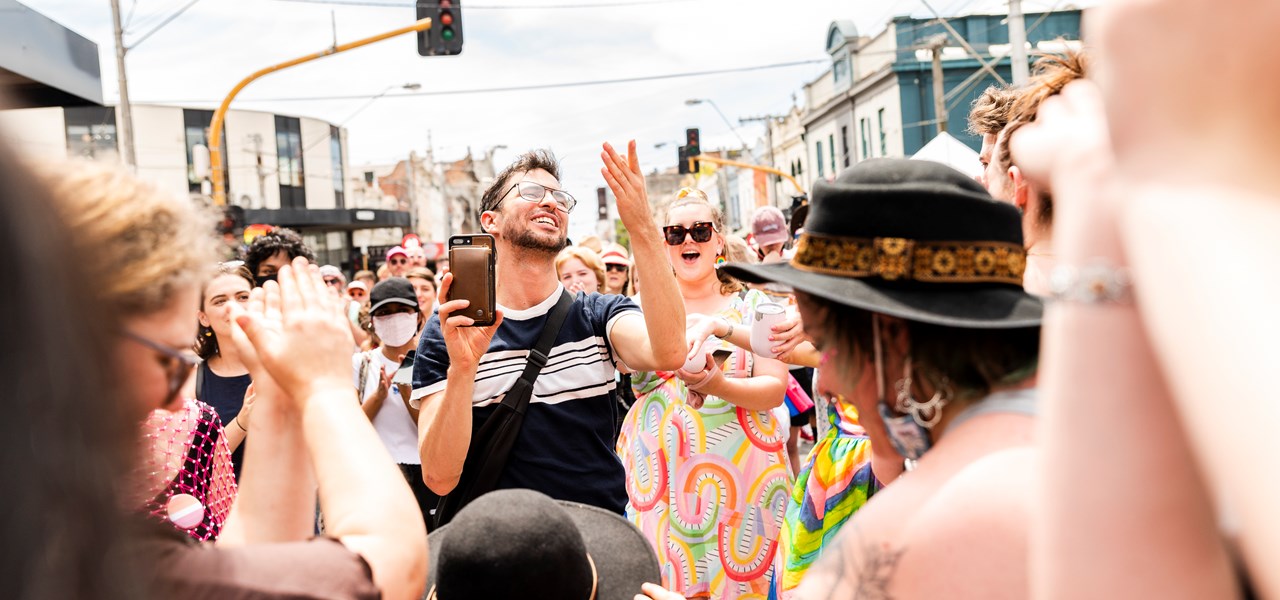 People dancing happily in the street at Melbourne Pride in 2022