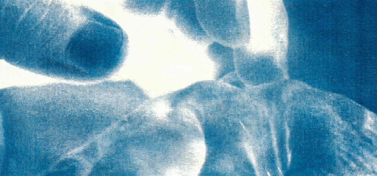 Two hands, cyanotype print. The toning has a monochrome look and the objects are a little blurred