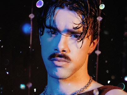Headshot of Max Lawrence in a club-like environment