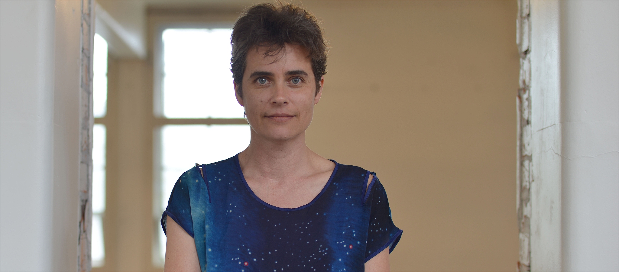 Pianist Danaë Killian looking wide-eyed, wearing the blue of the night sky.