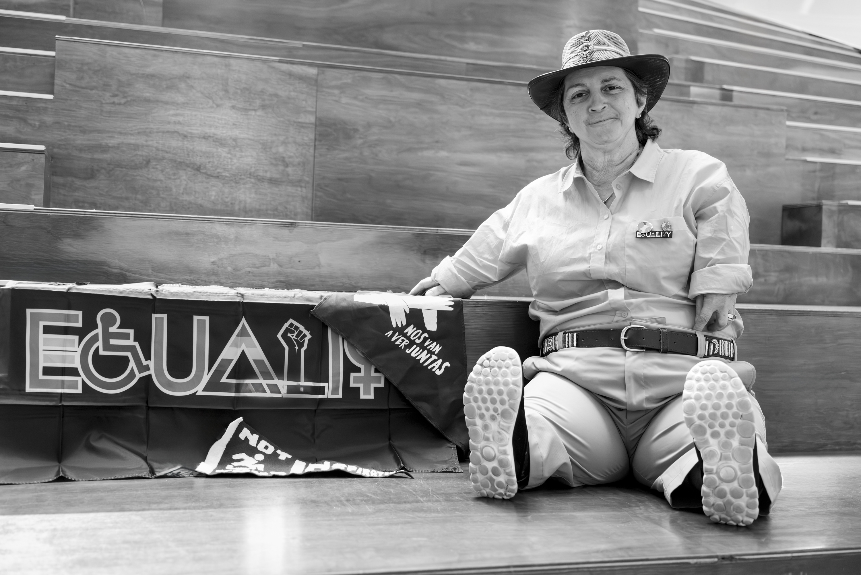 Margherita sitting on the steps at The Edge, Fed Square with a sign behind: EQUALITY