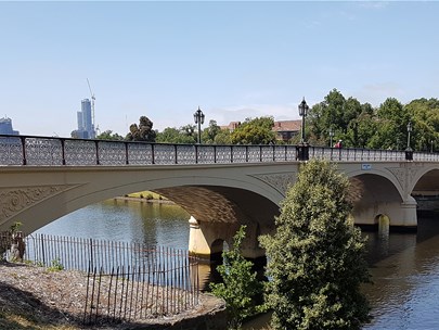 Photo of the Yarra River on a sunny day with the Morell Bridge in the foreground