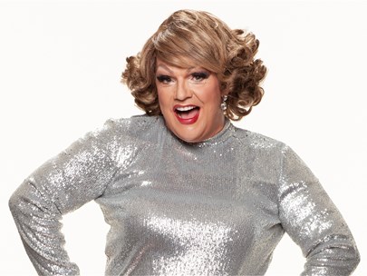Dolly Diamond in a sparkly grey outfit with red lipstick and silver earrings