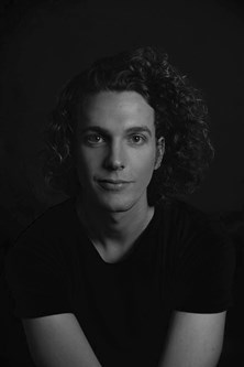 Black and white headshot of a person with long hair