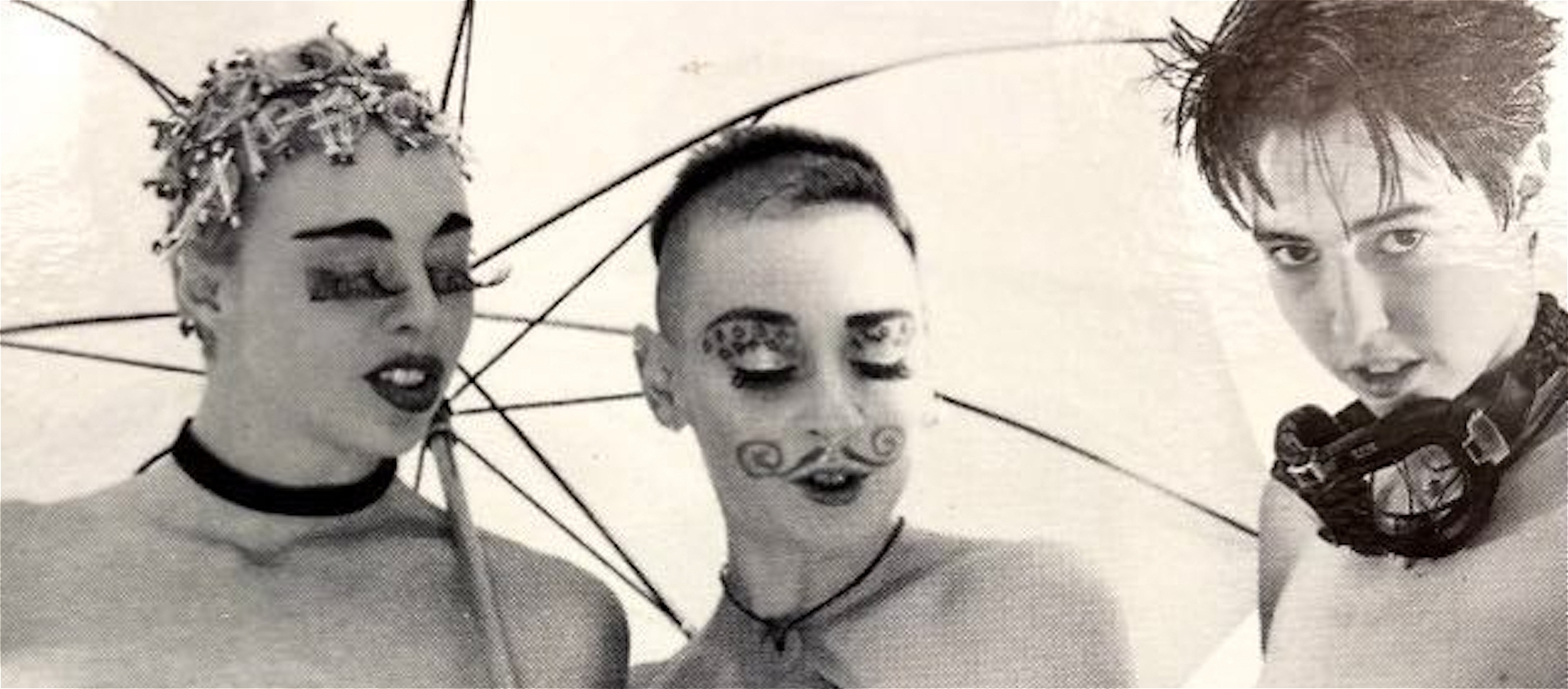 Imogen Kelly, Tiger Salmon are looking at Larissa's butch crotch.