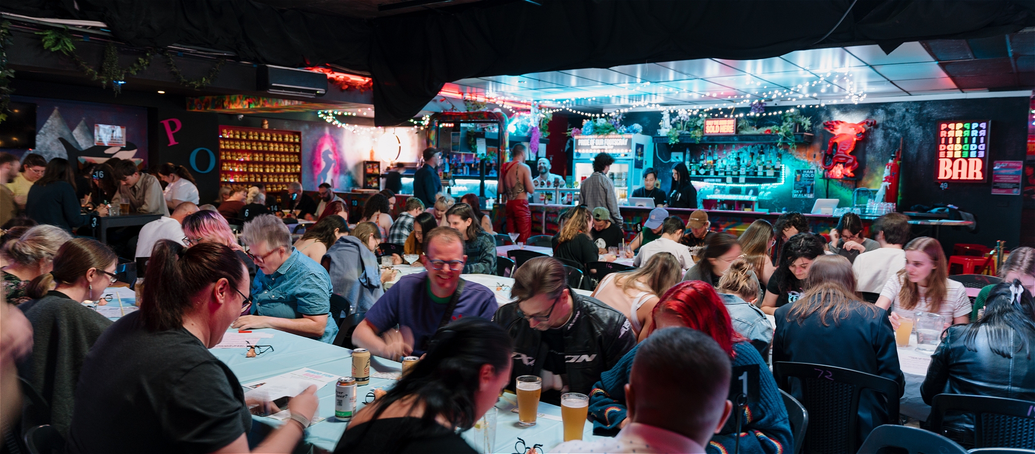 A crowded room of people sitting at tables ready to play bingo.