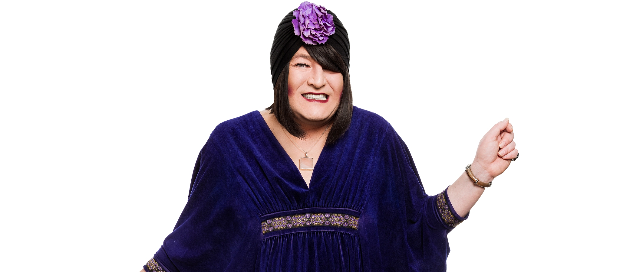 Tina Del Twist in centre frame staring straight at the camera with a smile with her left arm raised
