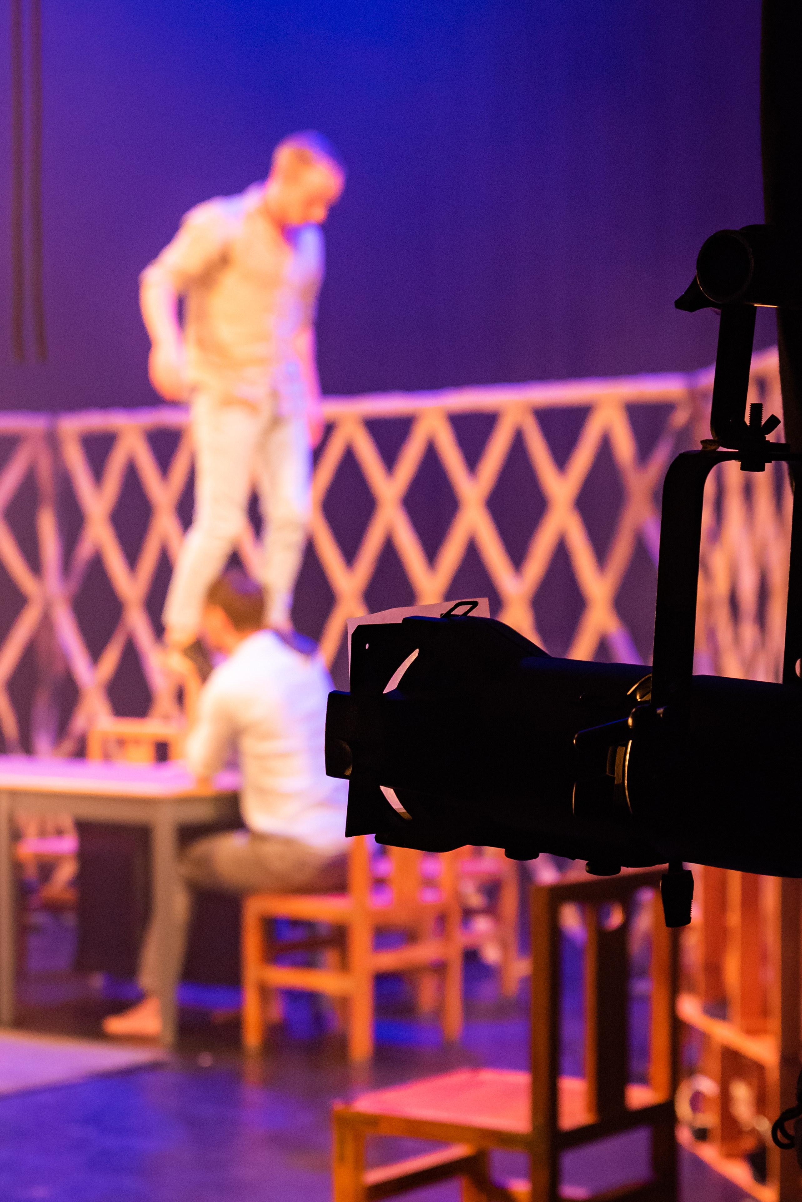 Phone held in a supporting bracket photographing a man sitting at a table - the man is out of focus
