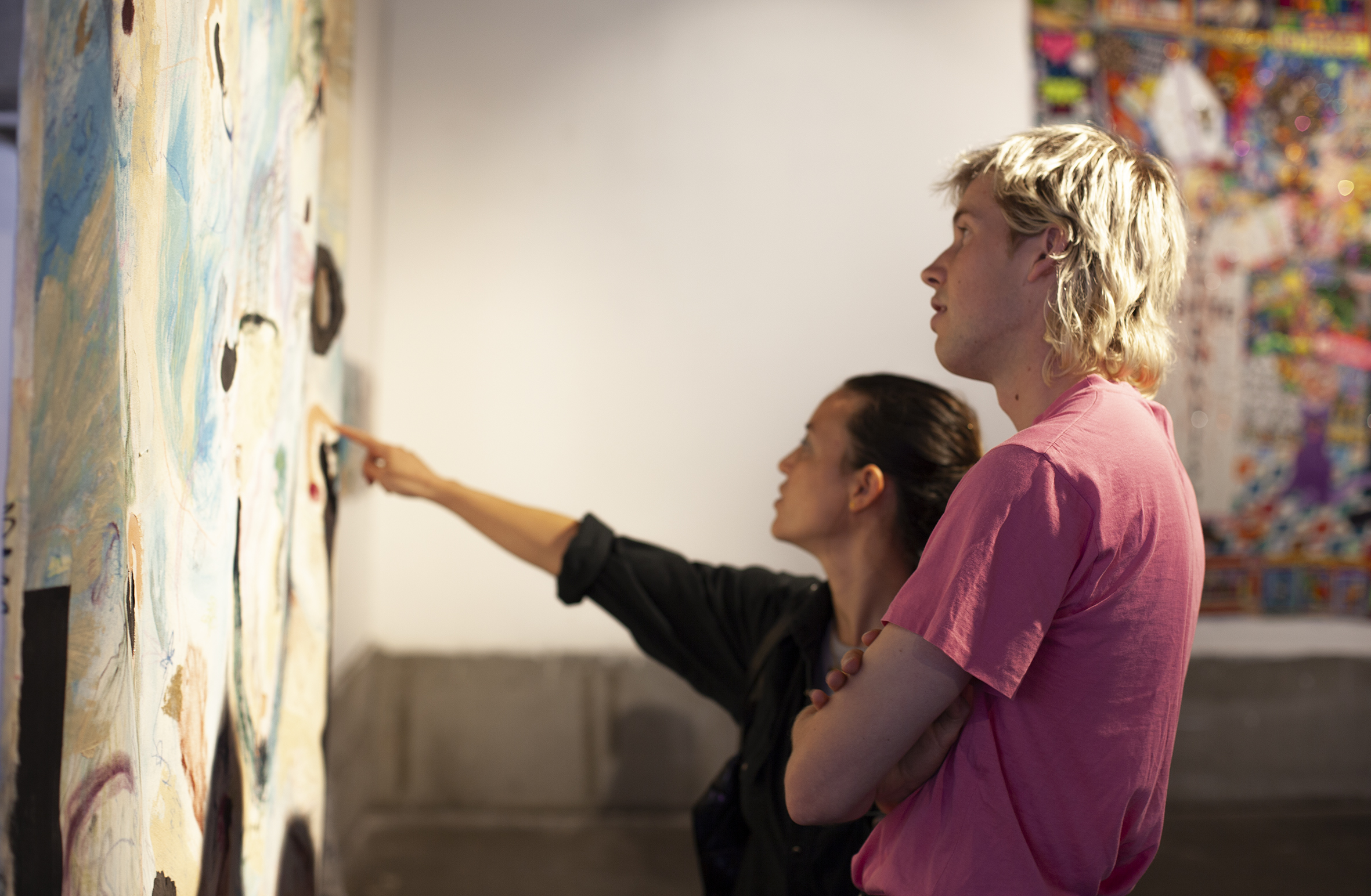 Two people admiring a large artwork