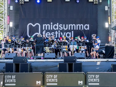 Melbourne Rainbow Band playing on stage at Midsumma Carnival 2022