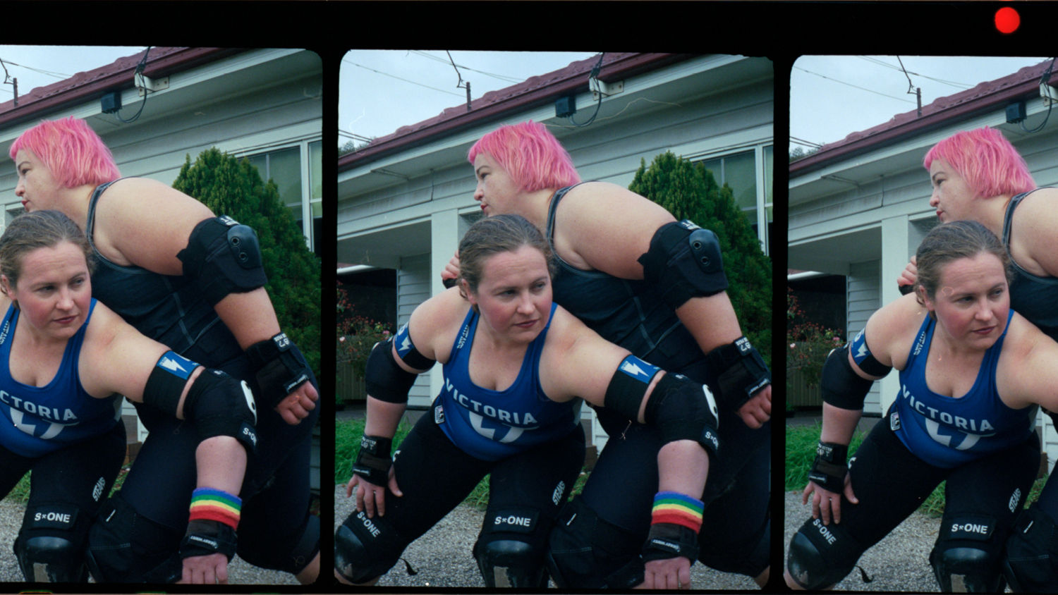 Three frames of a video showing two women roller skating in front of a suburban house