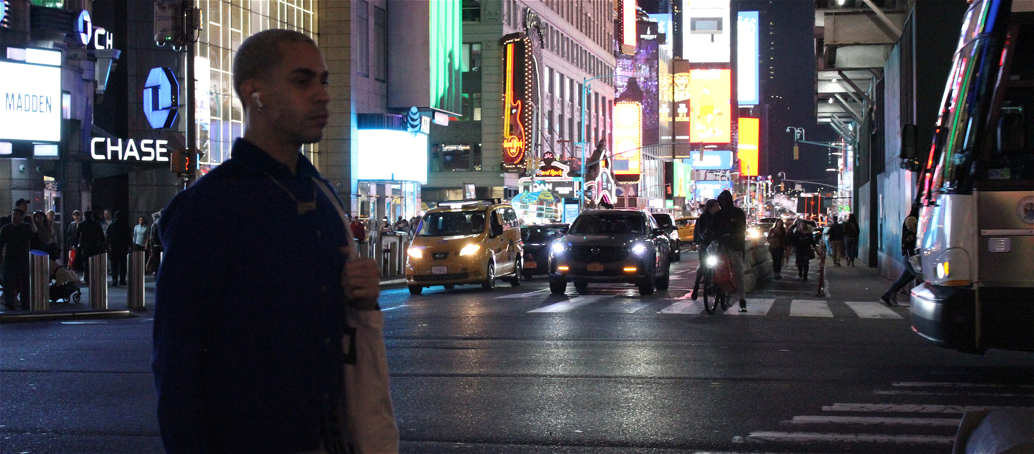 Young man walks with confidence through New York City Times Square