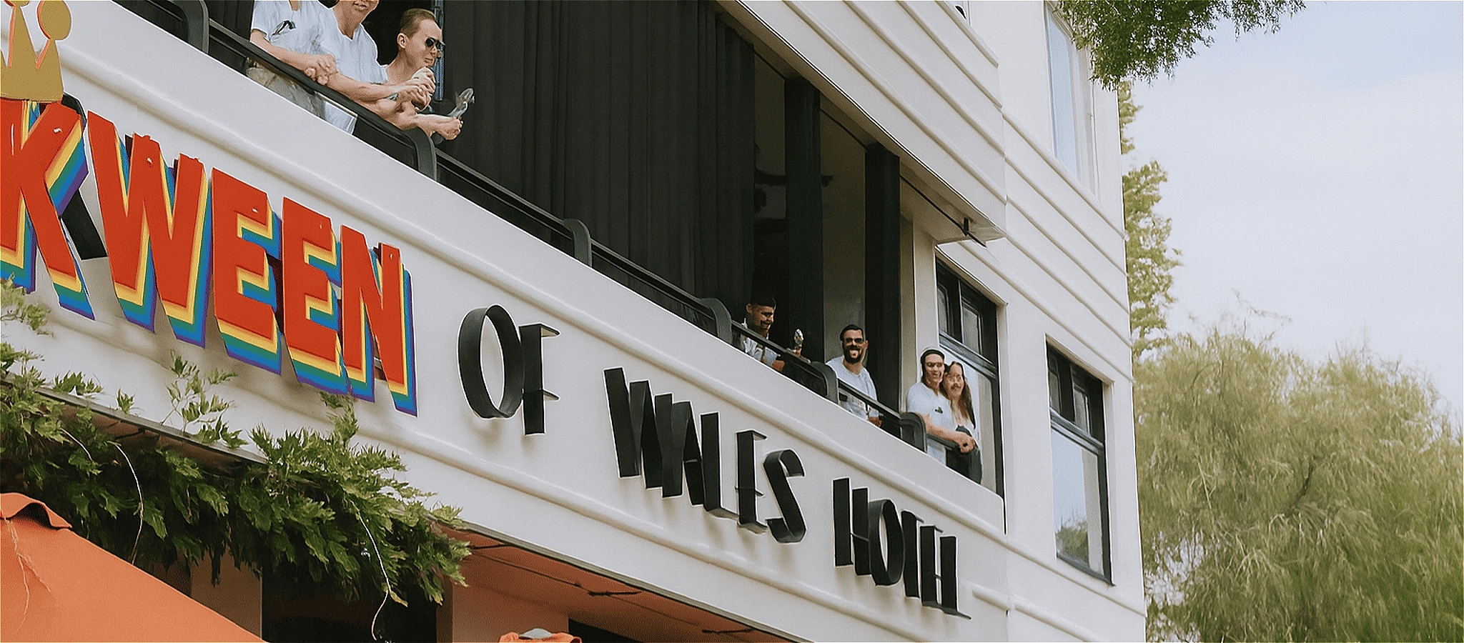 A sign on front of Prince of Wales building reads; Kween of Wales