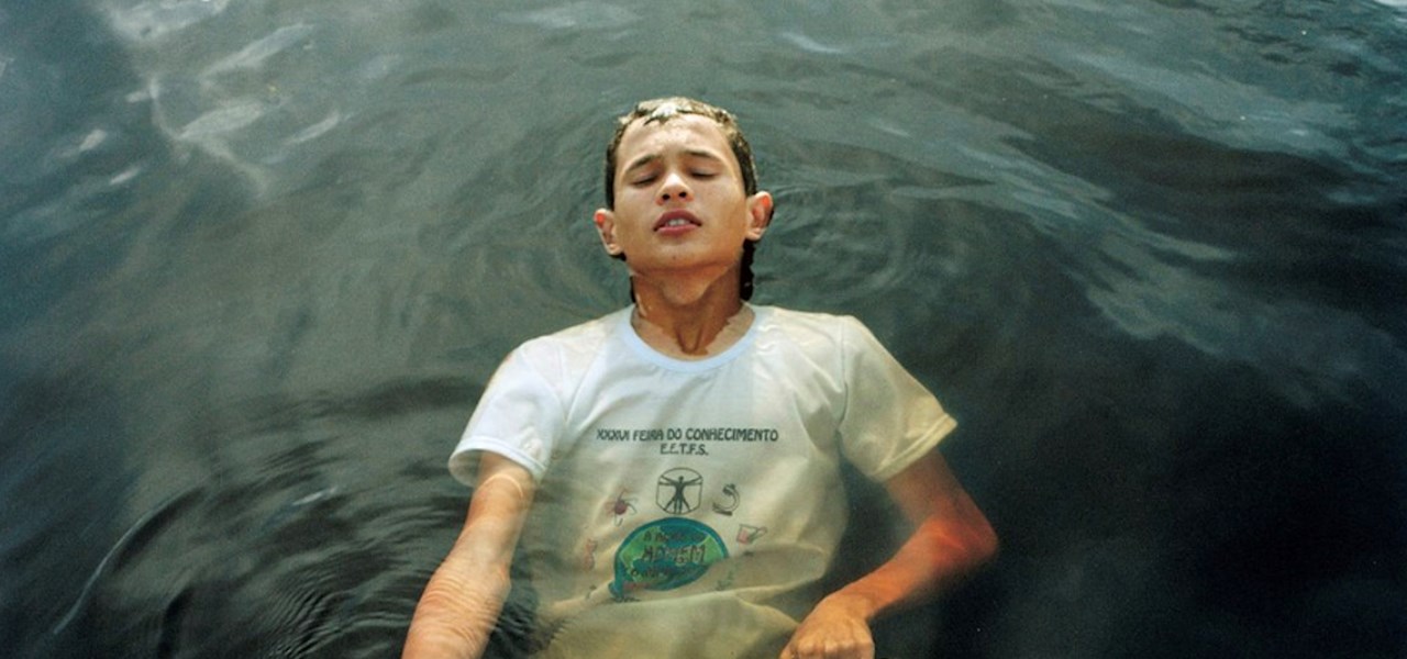 A person is gripping on to a rope while they are submerged in water.