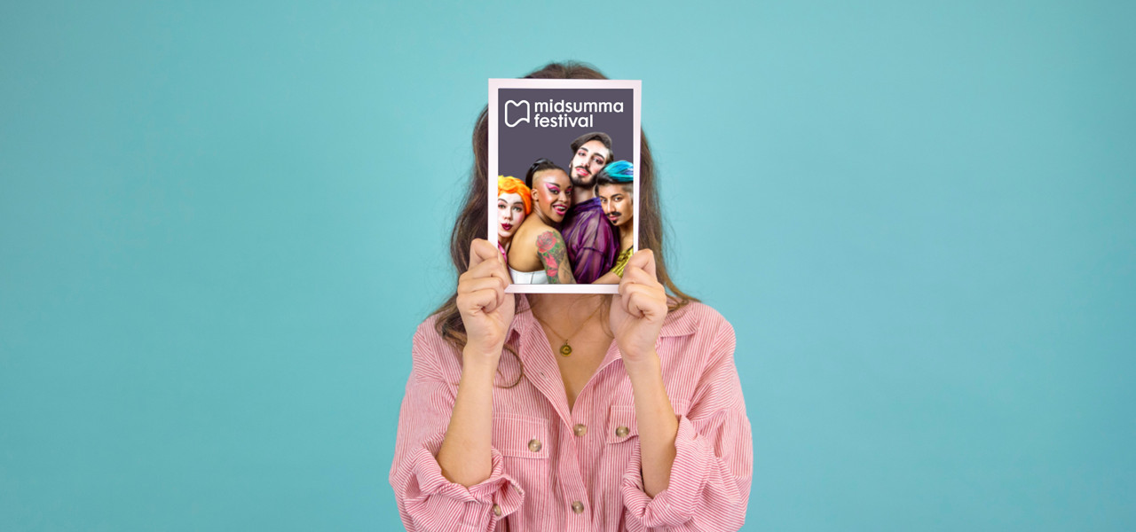 A person holding a Midsumma guide in front of their face