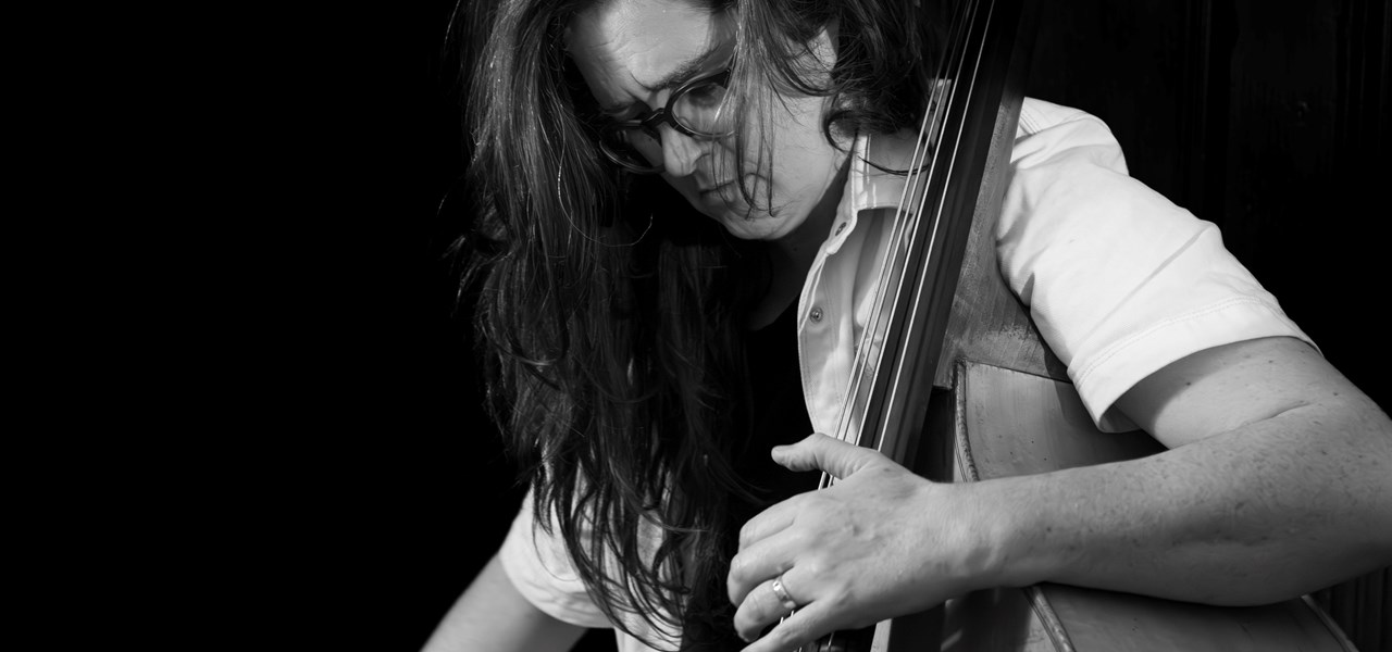 Miranda Hill looking concentrated while playing a double bass