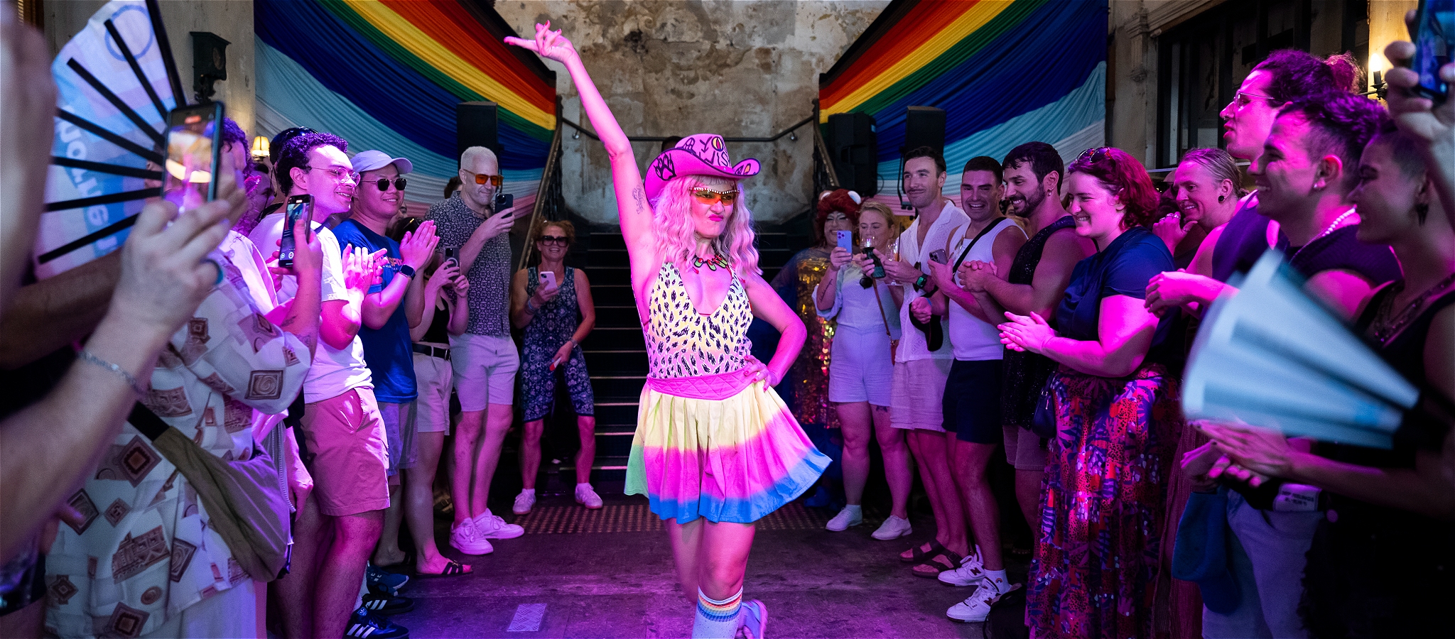 Person dressed as a cowgirl and performing to the crowd