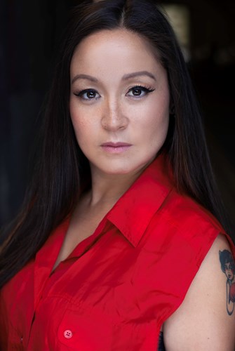 Headshot of Victoria wearing an elegant mauve dress