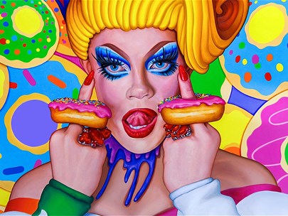 Portrait of transgender performer in bright costume with doughnuts on their fingers standing against brightly coloured background