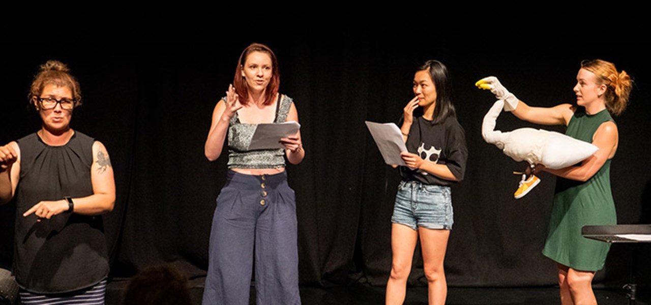 People on stage reading a play as part of the Queer Playwriting Award Showcase 2020