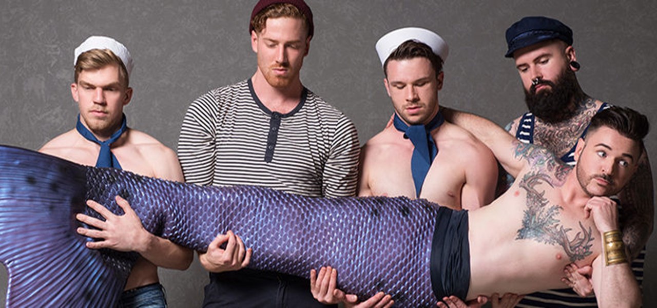 Four sailors, two bare-chested, holding a bare-chested merman horizontally