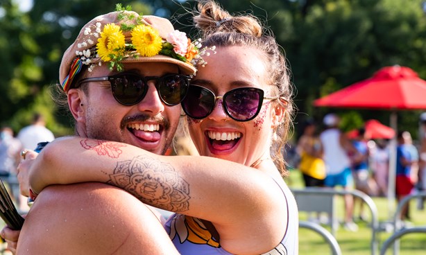 Two people embracing at what looks like Midsumma Carnival