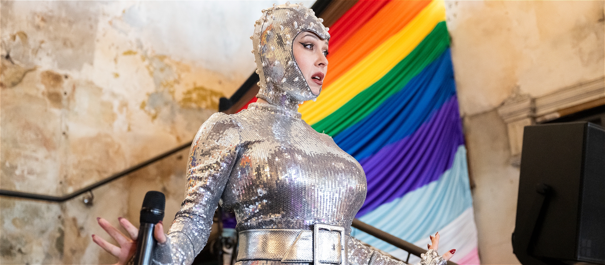 Performer dressed in silver on Espy stairs, singing