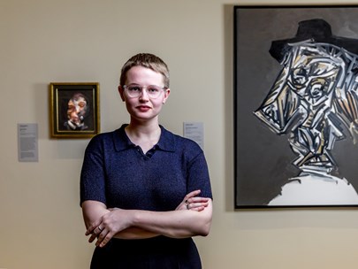 Meg Slater posing in front of art works