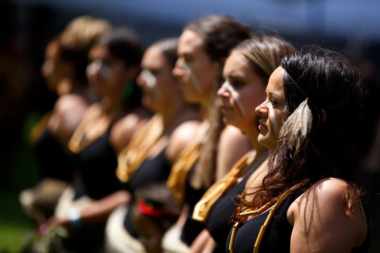 Members of the Djirri Djirri Dancers group standing in a line with only the front person in focus