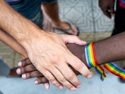 Various ethnicity hands with rainbow bracelet