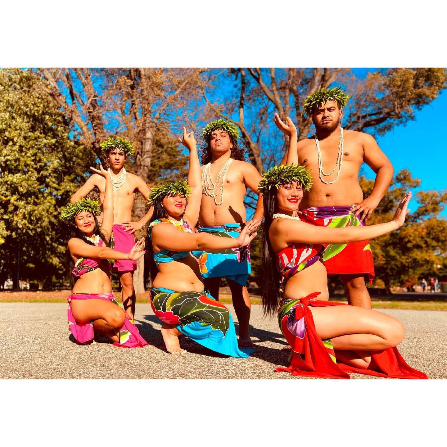 Six Pacifique Island people scantily dressed posing on a beach