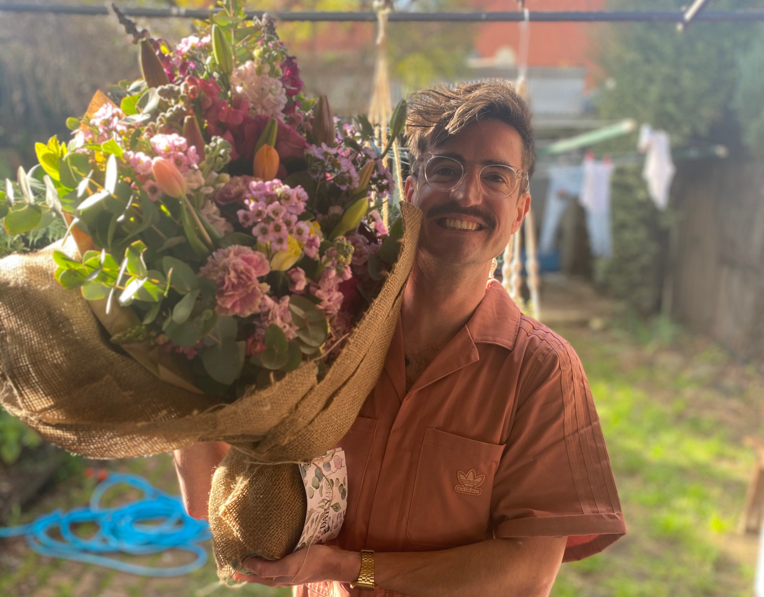 Martin holding a massive bunch of flowers