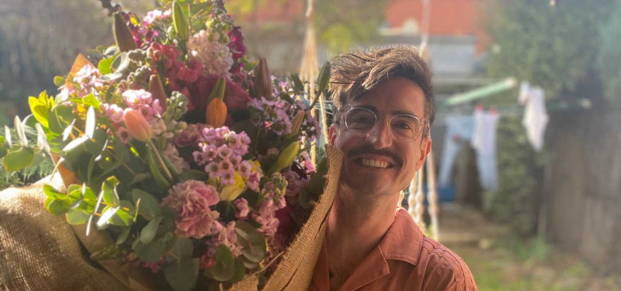 Martin holding a massive bunch of flowers