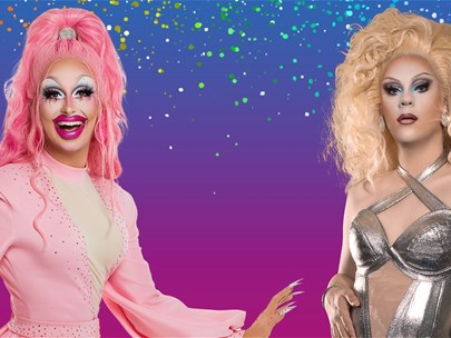 Two drag queens stand in front of a pink and purple background.