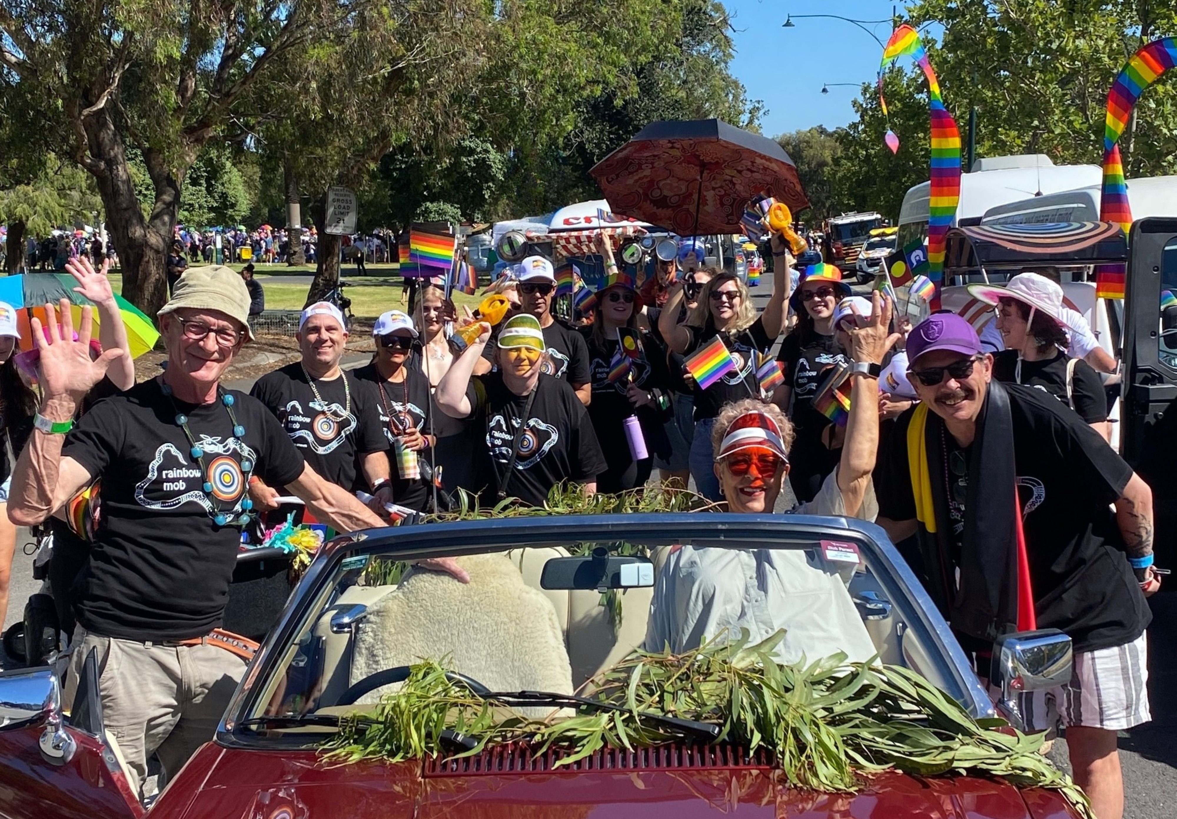 A happy looking mob located around the car in which Indigenous elders rode in at the start of the Pride March