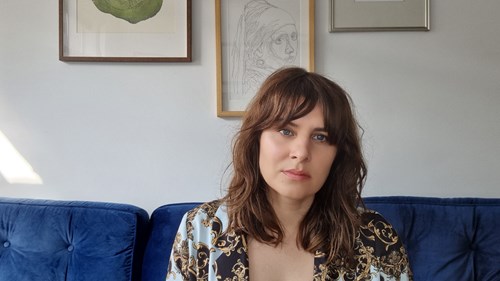 Headshot of Morgan in what appears to be a lounge room