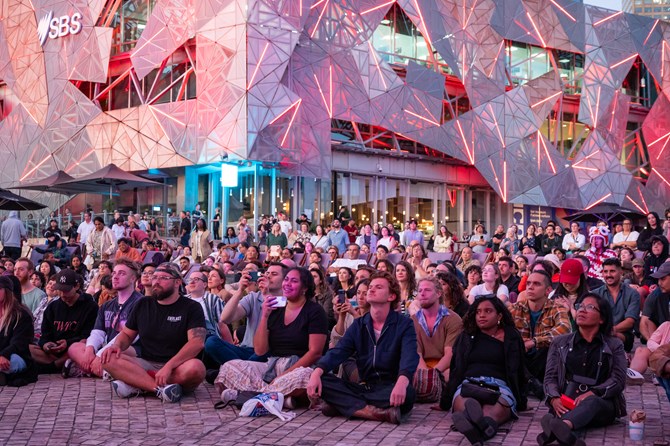 Large audience at Fed Square totally engaged with what is happening on the stage
