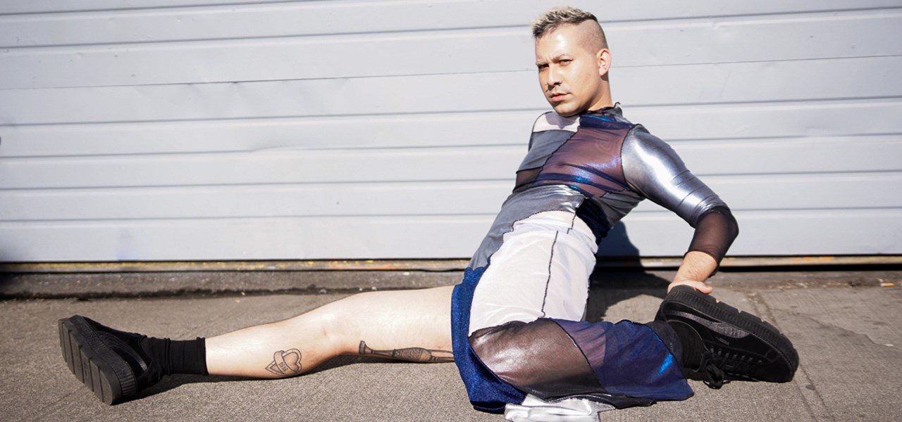 Man stretching in front of a garage roller door - one leg in front, one behind him