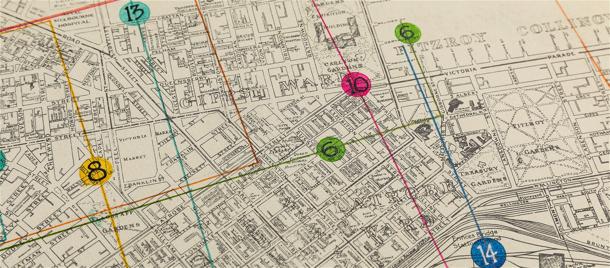 A black and white map of Melbourne overlayed with coloured lines and dots with numbers on them