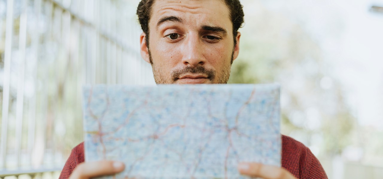 Person looking at a map with a quizzical expression