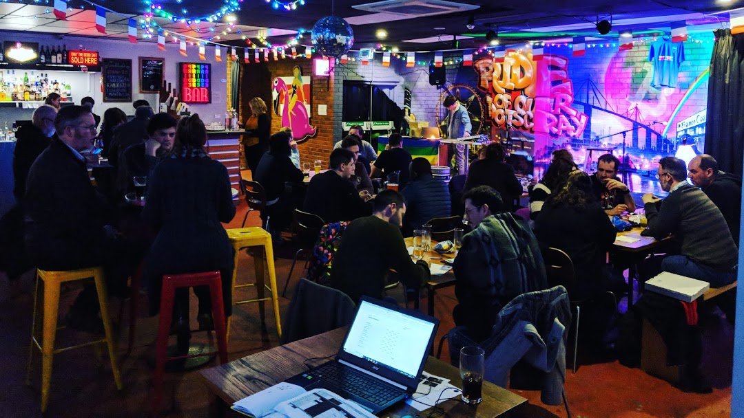People sitting in socially-distanced groups inside the main Pride Of Our Footscray bar