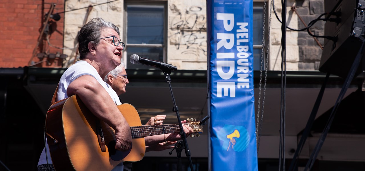 Midsumma Chair, Judy Small, playing guitar at Melbourne Pride