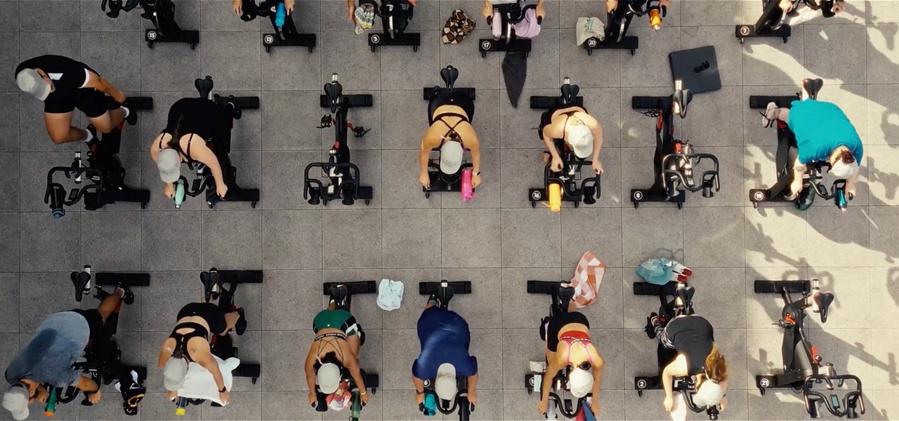 A group of people completing a spin class at the rooftop of the Pride Centre in 2023.