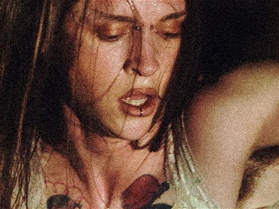 A cropped image of Alexander Powers in the throws of movement. Sweat drips from her face as she pants for breath.