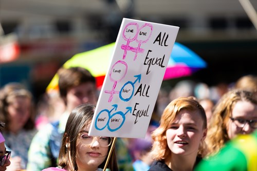 People holding a banner reading 'all equal'