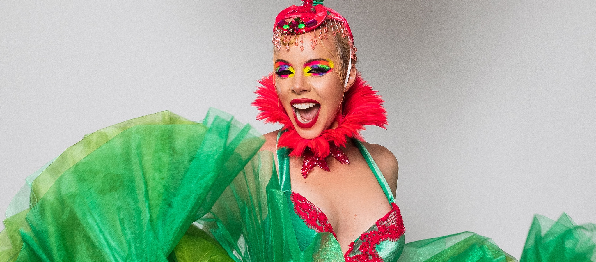 Imogen Kelly is flouncing in a massive bright green bustle with a HUGE smile.
