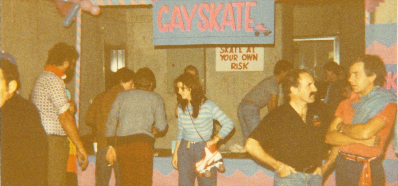 Skaters talking under the GaySkate sign at the Footscray Rollerskating Centre.